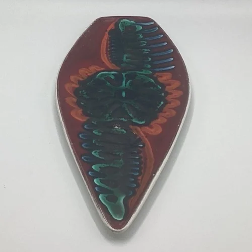 Angled view of Poole Delphis Shape 82 spear dish showing colourful abstract decoration