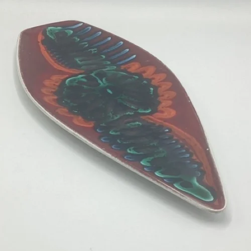Angled view of Poole Delphis Shape 82 spear dish showing colourful abstract decoration